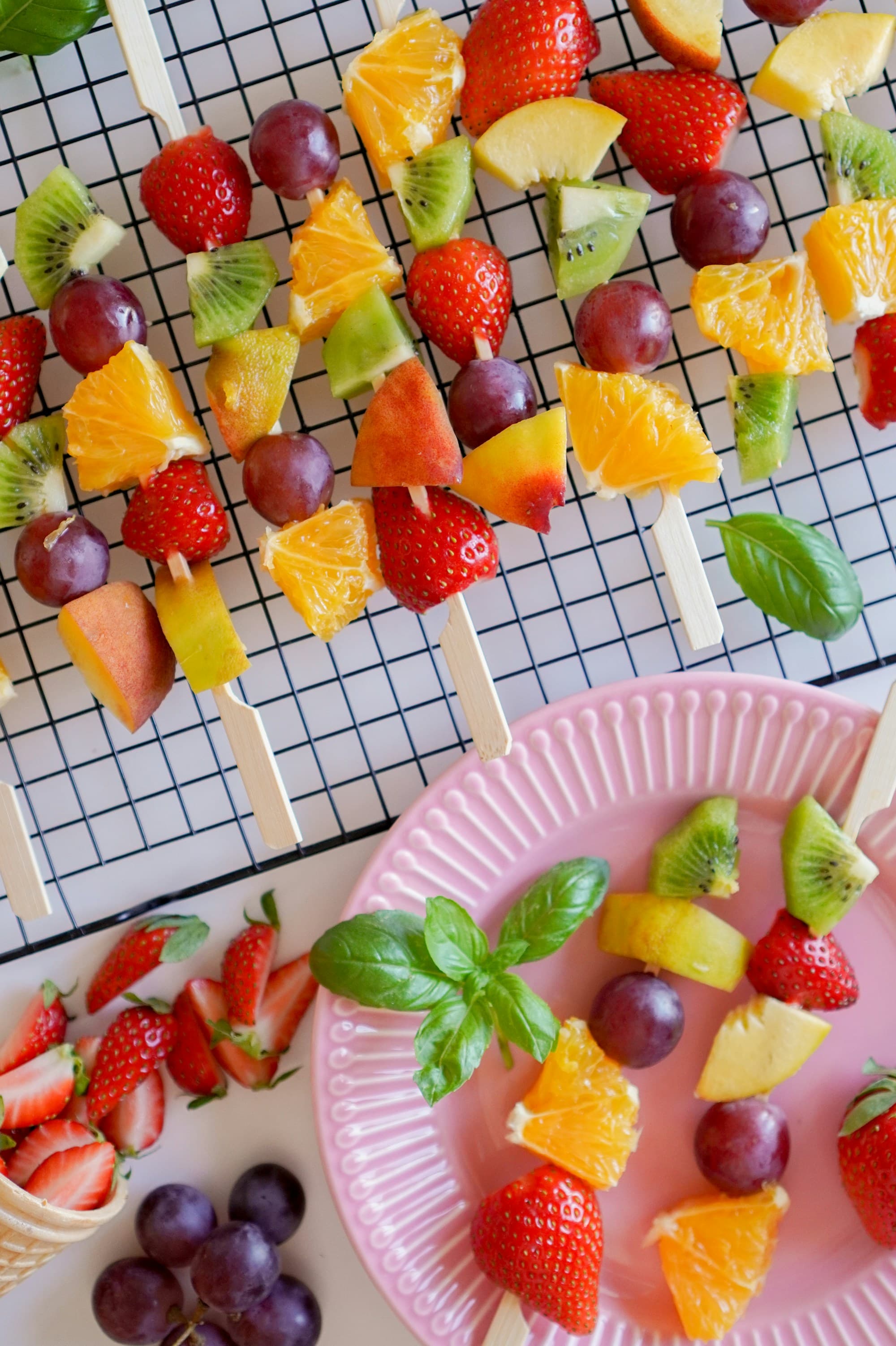 Colourful fruit skewers of strawberries, grapes and kiwi
